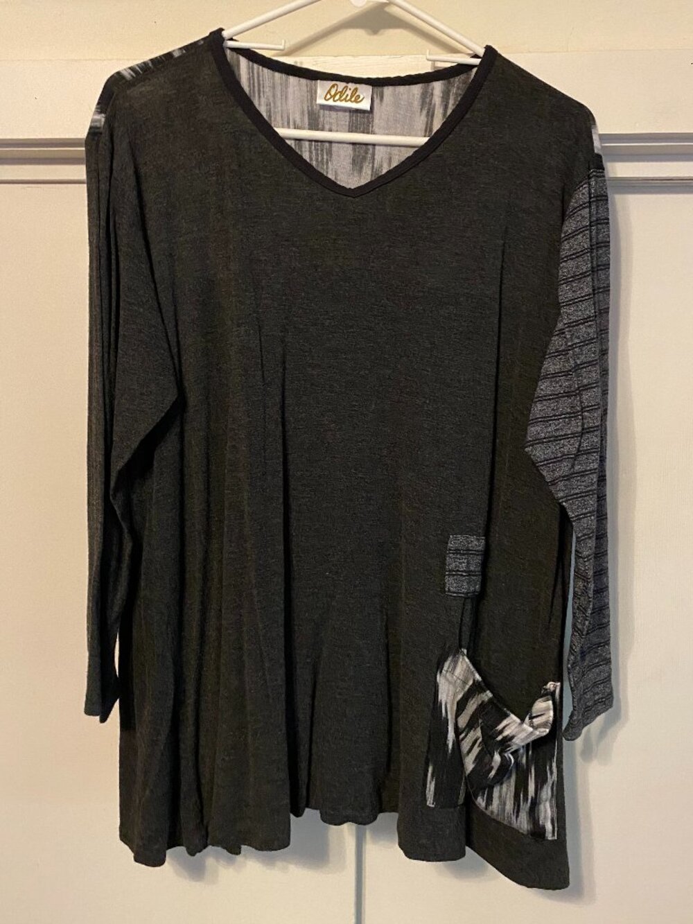Odille, black tunic w/contrasting designs on arms, back, etc., size L